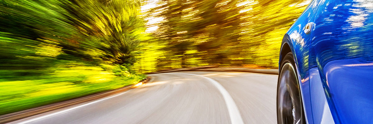 Blue car on a curved road